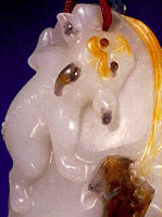Three colour Jade close up of a Seal and Pendant 