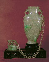 Celadon jadeite chained vase with rope strap work and cover, with 28 links, hints of lavender and apple green, well hollowed.