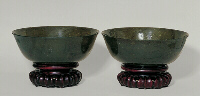 A pair of spinach green nephrite bowls with a seal inscribed on the base. 