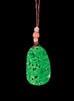 Reverse: Jadeite Pendant, bright green, carved and pierced with bamboo, prunus and ruyi fungus with a tropical long tailed bird down one side.