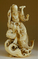 A fine ivory Okimono, carved from a solid tusk, of Kinko holding a scroll in one hand, and a staff in the other, whilst seated on a large carp above the waves.