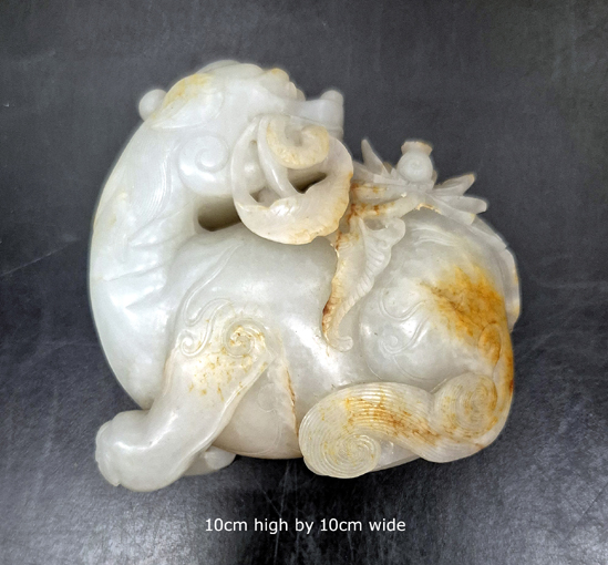 White and russet Nephrite carved as a mythological creature. 