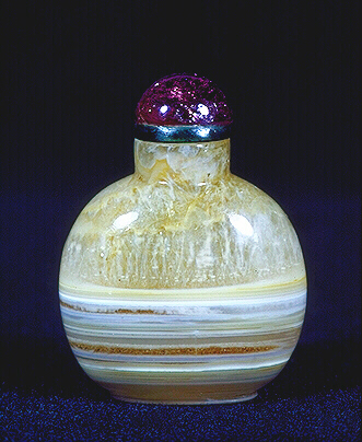 A beige, well hollowed, plain chalcedony ladies snuff bottle, with a pink tourmaline stopper. 