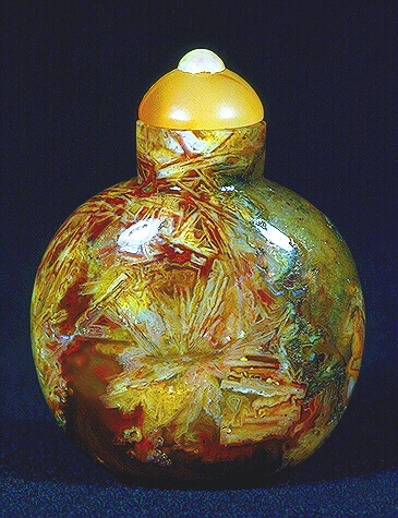 A quartz, agate and crystal, plain red starburst snuff bottle, well hollowed, with a carnelian & pearl stopper. 