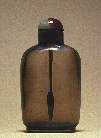 A smoky crystal plain snuff bottle, very well hollowed, with a green and brown jade stopper. 