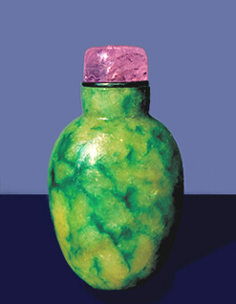 A plain mottled emerald-green and yellow, jadeite, well hollowed, snuff bottle with a tourmaline stopper. 