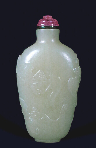 A mutton fat jade snuff bottle carved in relief with five bats and well hollowed. Tourmaline stopper. 