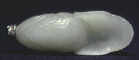 The tail provides a built in dish of the muttonfat nephrite snuff bottle carved in the form of a carp. A glass and metal stopper.