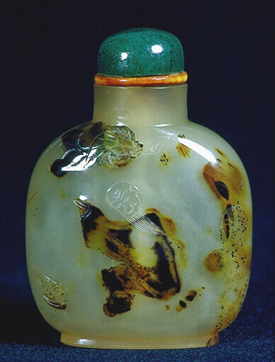 A chalcedony well hollowed silhouette picture snuff bottle. Green glass and ivory stopper. 