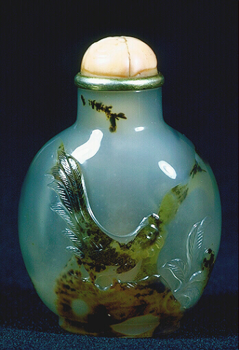 A chalcedony well hollowed silhouette cockerel picture snuff bottle with a coral and metal stopper. 