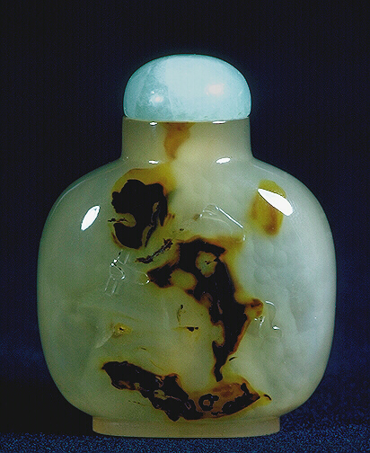 A chalcedony well hollowed silhouette torch bearer picture snuff bottle with a quartz stopper. 