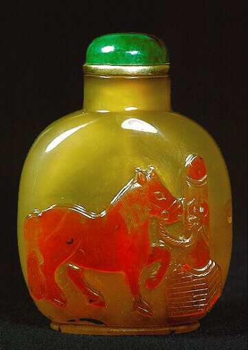 A chalcedony well hollowed cameo carved tethered horse picture snuff bottle with a green glass and metal stopper. 