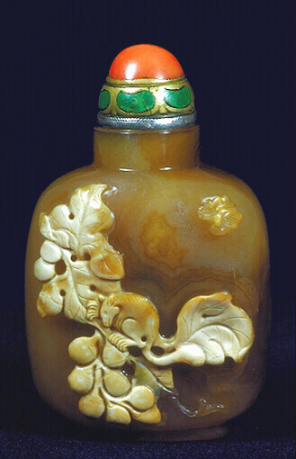 A chalcedony well hollowed cameo carved squirrel and grapes picture snuff bottle with a coral and enameled metal stopper. 