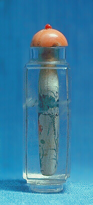 Side view of the Quartz, crystal snuff bottle, painted inside in ink and colour with a continuous aquatic scene of a fan-tailed carp swimming amongst lotus.