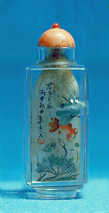 Reverse of the Quartz, crystal snuff bottle, painted inside in ink and colour with a continuous aquatic scene of a fan-tailed carp swimming amongst lotus.