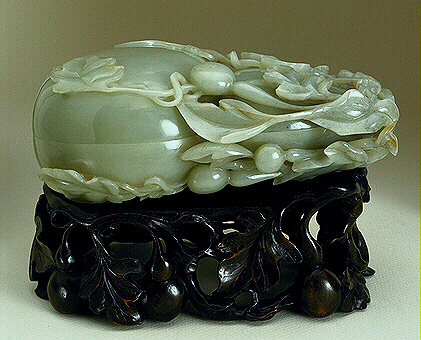 A large pale celadon jade stone.  Carved as a double gourd box, surrounded by foliage, and young gourds.