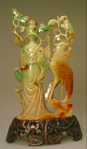 The reverse of the Celadon and russet jadeite carving of Guanyin with phoenix and flowers.