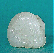 Another angle: Very white nephrite carving of an elephant resting with its body curled around a small boy reaching up to tickle the elephant's ear with a spray of lingzhi fungus. This is a fine small handling piece, about the size of the average netsuke.