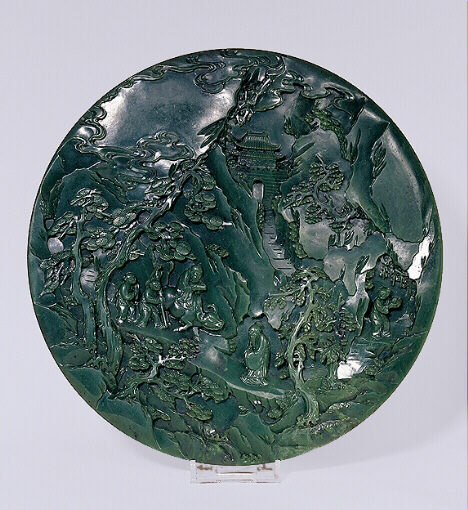 Spinach green jade circular screen with figures in a mountain landscape. Qianlong period.