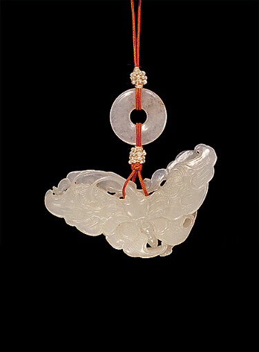 Nephrite Pendant, white carved in the form of a butterfly with long proboscis, the other side with a beetle amongst scrolling flowers and ruyi fungus.