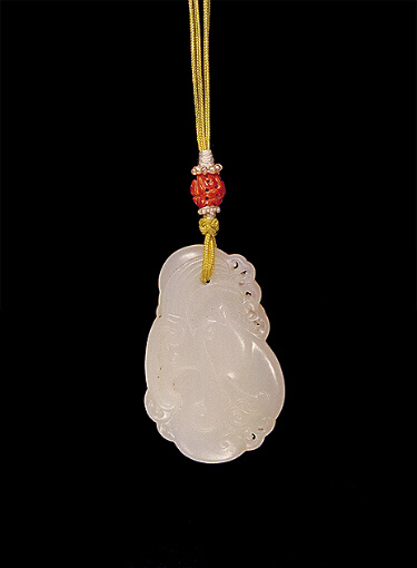 Nephrite Pendant, white mutton fat, carved with a formalised bird with plumage and waves.