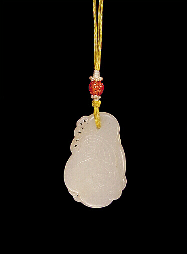 Reverse: Nephrite Pendant, white mutton fat, carved with a formalised bird with plumage and waves.