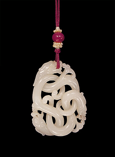 Nephrite Pendant, white mutton fat, brilliantly carved depicting three dragons chasing each other's tails, their bodies and tails twisted, convoluted and knotted.