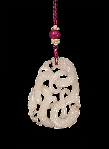 Reverse: Nephrite Pendant, white mutton fat, brilliantly carved depicting three dragons chasing each other's tails, their bodies and tails twisted, convoluted and knotted.