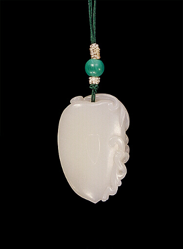 Reverse: White nephrite pendant carved in the form of a shield with a curling chilong with lingzhi in its mouth and another baby dragon clambering to the side.