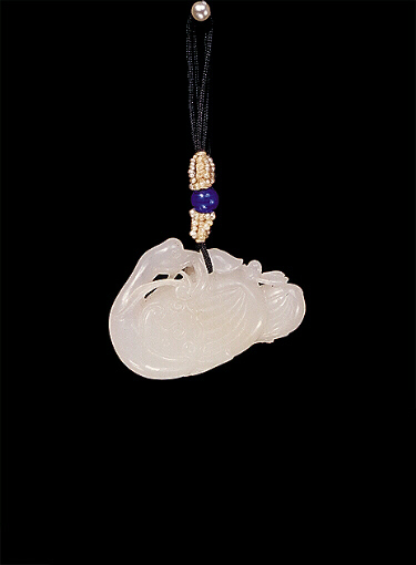 White nephrite pendant of a mother duck with duckling.