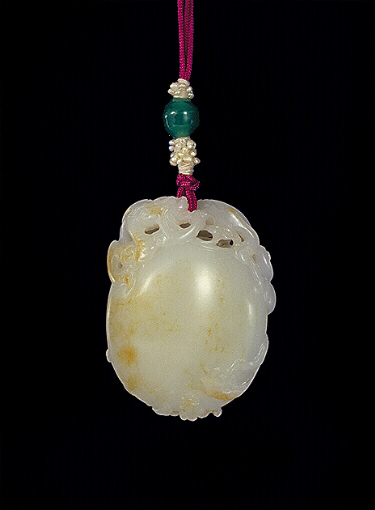 Russet nephrite pendant carved as a pearl with a large dragon protecting the pearl and two smaller dragons around the body.