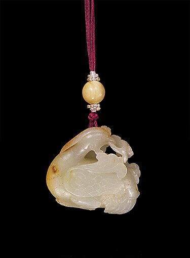 Nephrite Pendant, pale celadon colour with russet inclusions, carved with a duck, sprays of ruyi fungus, and a dragon.