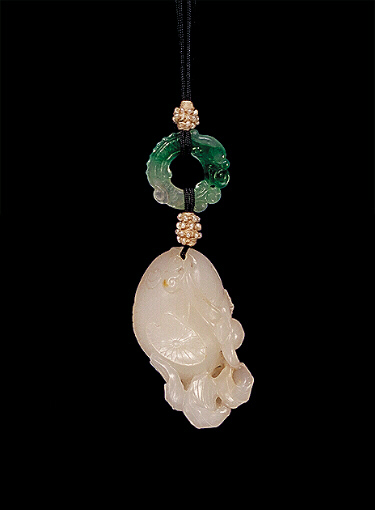 Reverse: Nephrite pendant, mutton fat with mottled russet skin carved as a plump fish with a spray of lotus in its mouth. A bright green jadeite ring in the form of a dragon biting its tail.