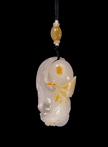 Nephrite pendant, mutton fat with some russet skin areas carved as a persimmon fruit with a beetle on iits leaf. 