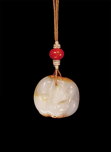 Nephrite pendant, mutton fat with brown russet skin carved in the form of two reclining and cuddling animals.