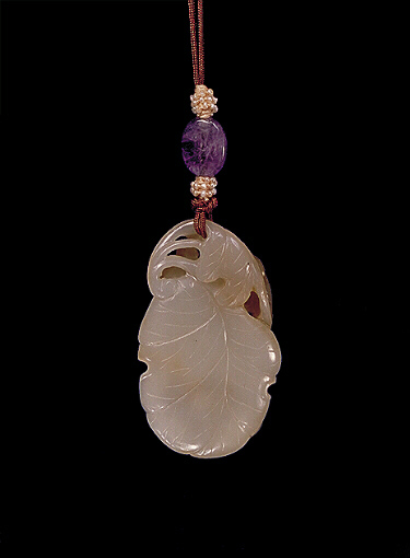 Reverse: Nephrite pendant, pale celadon with a darker olive area carved with two squirrels amongst grapes on a leaf.