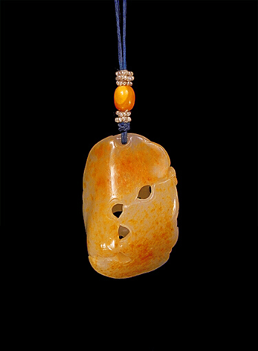 Reverse: Nephrite pendant, a pebble with russet brown skin, the body of white mutton fat pierced and carved with lotus flowers, leaves, stalks and buds.