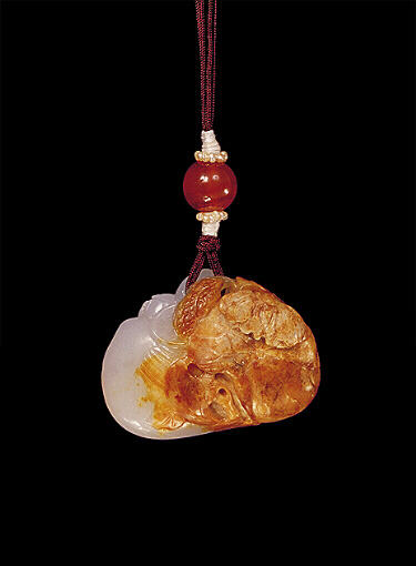 Reverse: Nephrite pendant, russet brown and white, carved with a duck, its wings swept up with lotus and millet, and leaves on the other side.