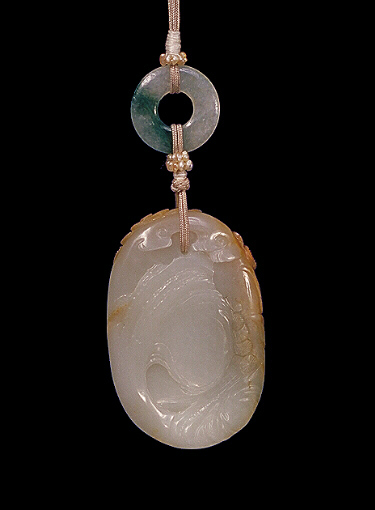 Reverse: Nephrite pendant, pale grey, with slightly browner skin, with a monkey against a rocky landscape holding his prize gained from the trees above, the reverse with craggy rock work. Suzhou School.