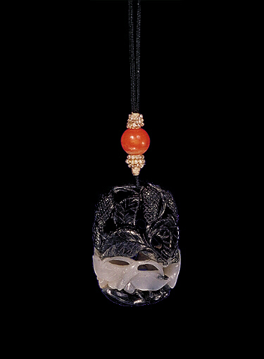 Nephrite pendant, mutton fat white with black, carved with two butterfly and a bee with a mulberry fruit and leaves above.