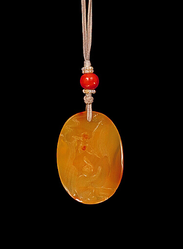 Reverse: Chalcedony pendant, pale translucent, orange agate carved with a reclining horse on a rocky landscape, the other side with a monkey down amongst rocks and water looking up at tempting peaches. Suzhou School.