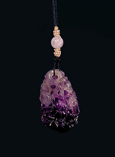 Amethyst pendant, with milky inclusions and a dark purple area carved with a bat amongst a double gourd vine, the bottom of the pendant forming the deeper colour and the larger part of the gourd.