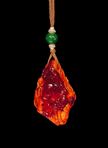 Amber pendant, of dark translucent golden colour with opaque paler material carved with a tiger from the translucent material and a dragon amongst clouds from the opaque material, the foot carved with a personal seal.