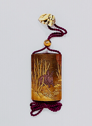 Japanese Inro, two hares among tokusa grass beneath the Moon, with an ivory hare netsuke.