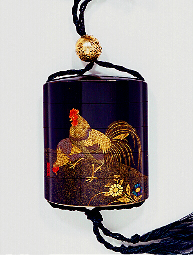 Close-Up: Japanese inro of a cock and hen with a pierced floral design metal ojime.