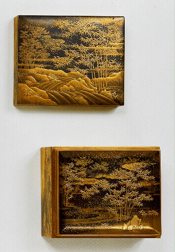 Japanese Lacquer: A Kogo decorated all over, including the tray, in gold on black with bamboo growing beside a running stream.