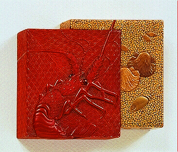 A Kobako of two overlapping boxes; one of tsuishu carved in relief with a crayfish on a wave ground, the other with gold takamakie shells.