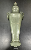 Sage green well hollowed jade vase, with loose rings on shoulders and a lid with a mounted ruby. Qianlong period. 