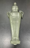 Reverse: Sage green well hollowed jade vase, with loose rings on shoulders and a lid with a mounted ruby. Qianlong period. 