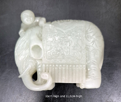 Nephrite white/celadon carved as a boy with an elephant. 